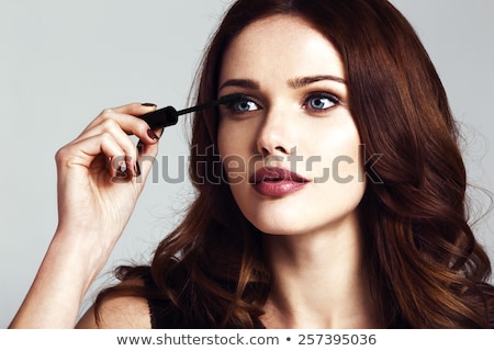 [[stock_photo]]: Hand Applying Mascara To Beautiful Woman