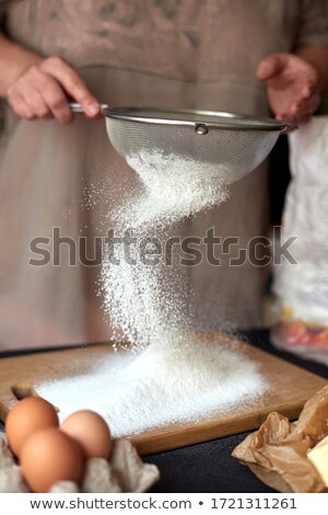 Stock photo: Hands Sifts Almond Flour For Cake Baking