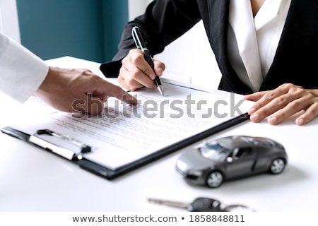 Stock fotó: Closeup Of Businessman With Key And Paper Agreement