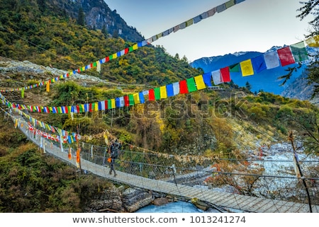 Сток-фото: Woman Backpacker Crossing Suspension Bridge In Himalayas Nepal