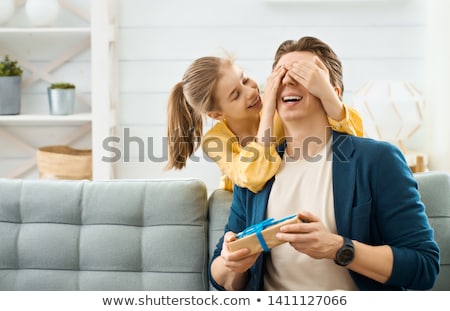 Foto stock: Baby Girl With Birthday Gift And Parents At Home