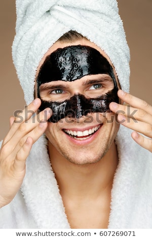 Stock photo: Happy Man With Black Mask On The Face Photo Of Man Receiving Spa Treatments Beauty Skin Care Conce