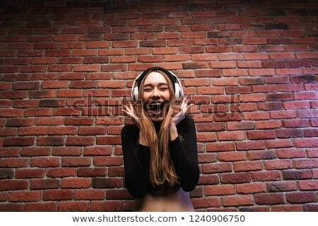 Foto d'archivio: Image Of Young Hip Hop Woman 20s Wearing Headphones Listening T