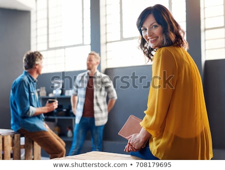 Zdjęcia stock: Happy Young Businesswoman Sitting At Her Workplace