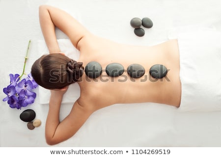 Stock photo: Young Woman Gets A Hot Stone Massage