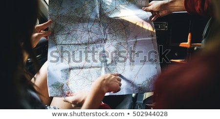 Foto stock: Couple Reading A Map In A Forest