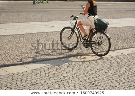 ストックフォト: Unrecognizable Cyclist Using Smartphone