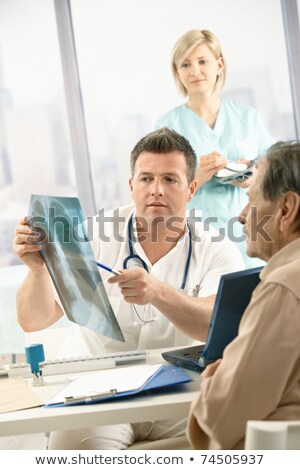 Zdjęcia stock: Doctor And Nurse Discussing An Xray