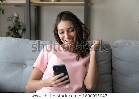 Foto stock: Young Woman Reading A Message On The Phone