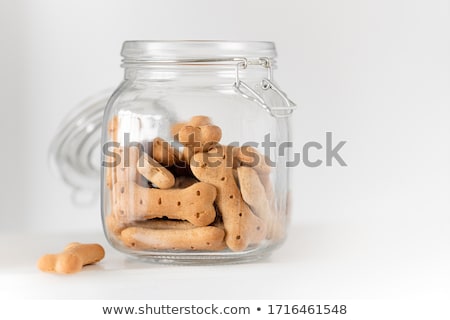 ストックフォト: Homemade Dog Biscuits Spilling From A Glass Canister