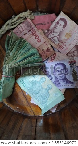 Foto stock: International Currencies Bank Note In The Bucket