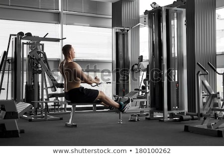 Stock photo: Athletic Bodybuilder Execute Exercise In Sport Gym Hall