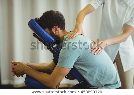 Foto stock: Physiotherapist Giving Back Massage To Female Patient