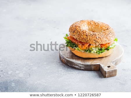 ストックフォト: Fresh Healthy Bagel Sandwich With Salmon Ricotta And Lettuce In Grey Plate On Light Kitchen Table B