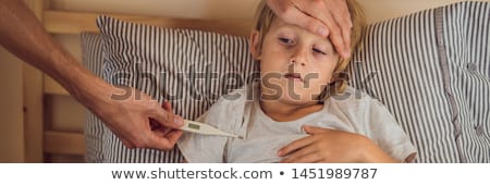 Stock photo: Banner Long Format Sick Boy With Thermometer Laying In Bed And Father Hand Taking Temperature Fath