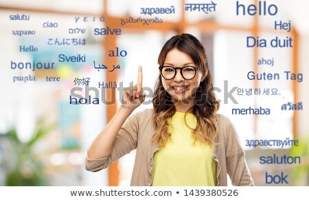 Сток-фото: Asian Woman Pointing Fingers To Foreign Words