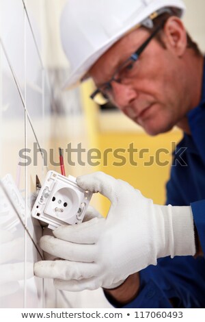 Stock photo: Electrician Fitting Electrical Outlet