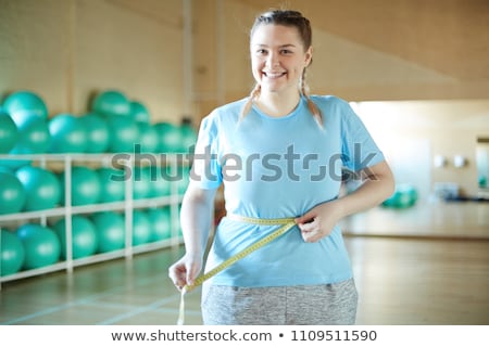 Foto stock: Happy Young Plus Size Woman With Measuring Tape