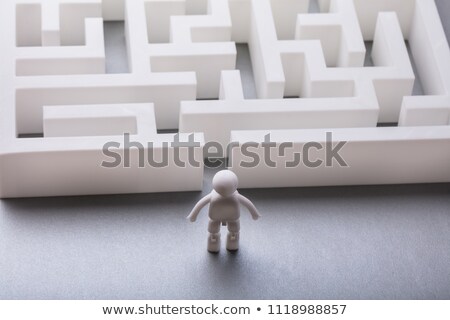 Stockfoto: Human Figure Standing Outside Maze Entrance