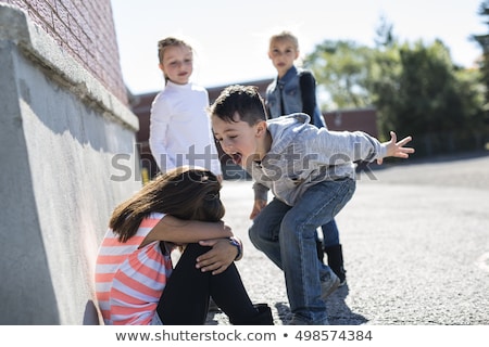 Foto stock: Elementary Age Bullying In Schoolyard