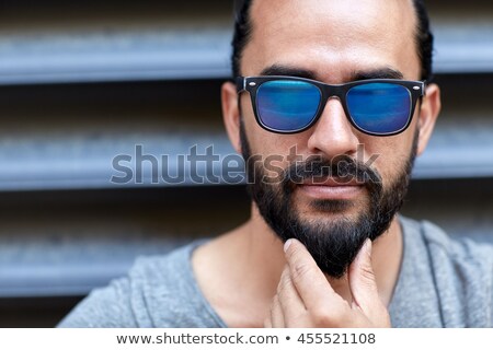 Сток-фото: Man In Sunglasses Touching Beard On City Street