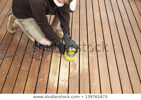 Man With Power Sander Kneeling Stock foto © tab62