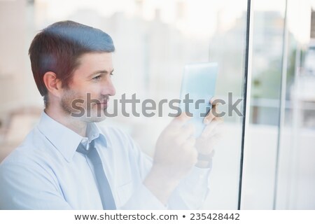 Stock photo: Businessman Scrolling Through His Tablet Pc