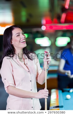 Stok fotoğraf: Young Beautiful Woman Chalking The Snooker Cue And Smiling