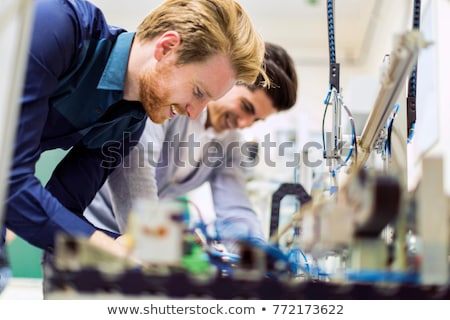 Stok fotoğraf: Two Young Handsome Engineers Working On Electronics Components