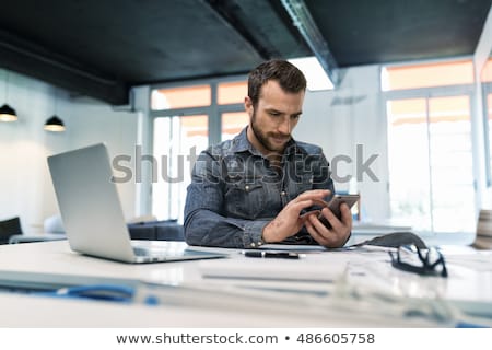 Сток-фото: Man Chatting By Phone And Using Laptop Computer