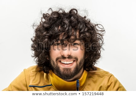 Stockfoto: Portrait Of A Cheerful Young Man With Curly Hair