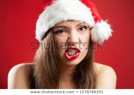 Imagine de stoc: Woman With Red Lipstick In Santa Hat At Christmas
