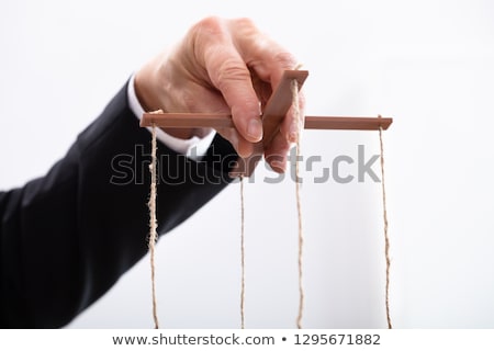 Foto d'archivio: Close Up Of A Businessman Manipulating Marionette