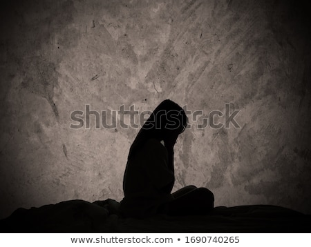 Foto stock: Sad And Lonely Girl Beside Wall