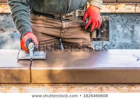 Stock fotó: Construction Worker Using Hand Groover On Wet Cement Forming Cop