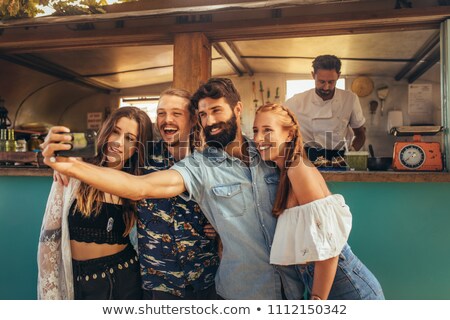 Stockfoto: Portrait Of Happy Couple Standing Near Food Truck