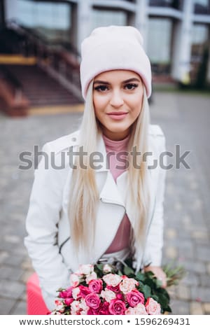 Foto stock: Beautiful Young Woman Holding Pink Rose Isolated