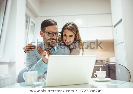 Stok fotoğraf: Couple Using A Laptop In A Restaurant