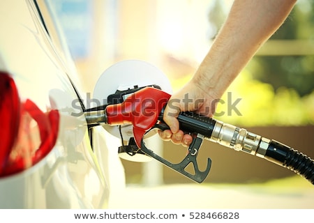 Foto stock: Mans Hand Refilling The Car With A Gas Pump