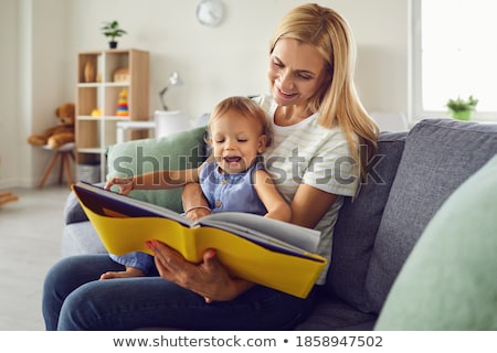 Stok fotoğraf: Cute Happy Toddler Sitting On Loving Mothers Knees