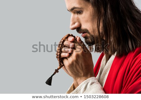 Stock fotó: Profile Of Handsome Man Holding Rosary And Praying