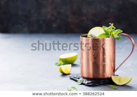 [[stock_photo]]: Cold Moscow Mules Cocktail With Ginger Beer Vodka Lime Grey Stone Background