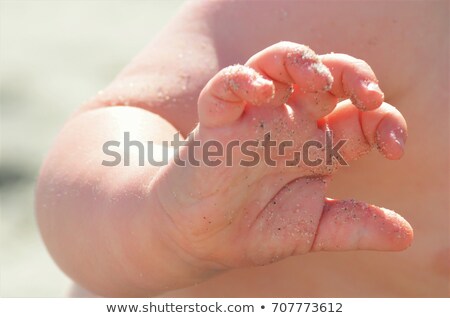Stock photo: Child With Sandy Hands On Beach