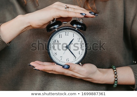 Foto d'archivio: Pregnant Female With Vintage Alarm Clock