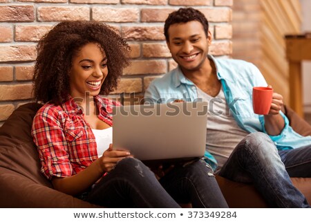 Zdjęcia stock: Couple Using Laptop Together On Chair