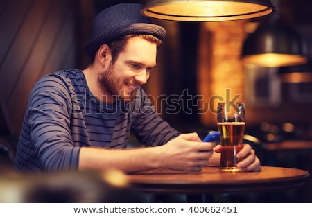 Zdjęcia stock: Man With Smartphone Drinking Beer At Bar Or Pub