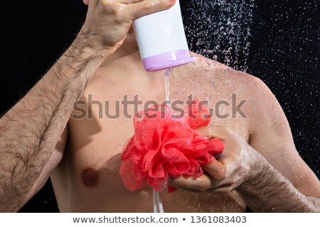 Foto stock: Man Taking Shower Putting Gel On Sponge