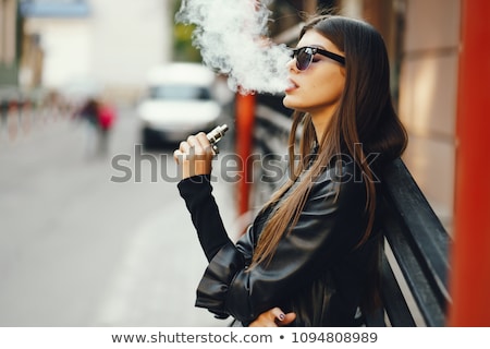Stock photo: Woman Smoking E Cigarette