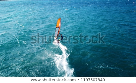 Foto stock: Girl Surfer Paddling On Surfboard To The Open Sea