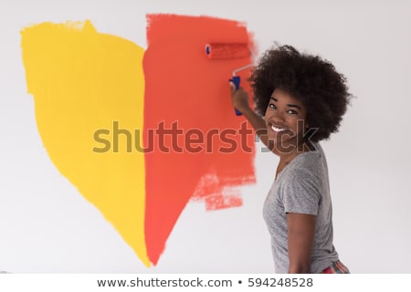 Foto d'archivio: Young Smiling Woman Painter With Paintbrush Standing